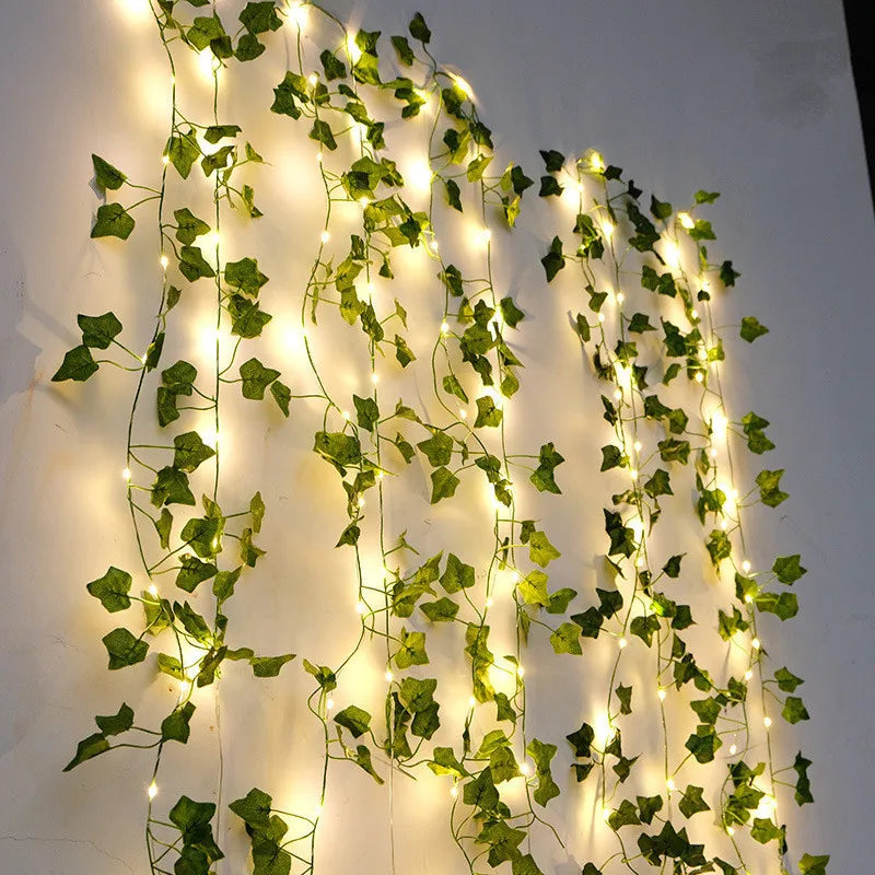 Garden Vine LED string lights with warm white LEDs and artificial ivy leaves on outdoor pergola battery powered