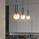 Orbit Glow Marble Brass Pendant with 12 cm marble sphere black ring frame and gold plated brass accents