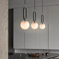 Orbit Glow Marble Brass Pendant with 12 cm marble sphere black ring frame and gold plated brass accents
