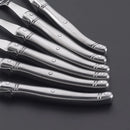 Elegant stainless steel flatware set with a polished finish, ergonomic handles, and precision steak knives
