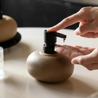 Ceramic pebble soap dispenser with matte black pump bathroom accessory