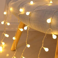 Fairy LED String Lights coiled with battery pack and plug, 33 ft, warm white, star and ball bulbs