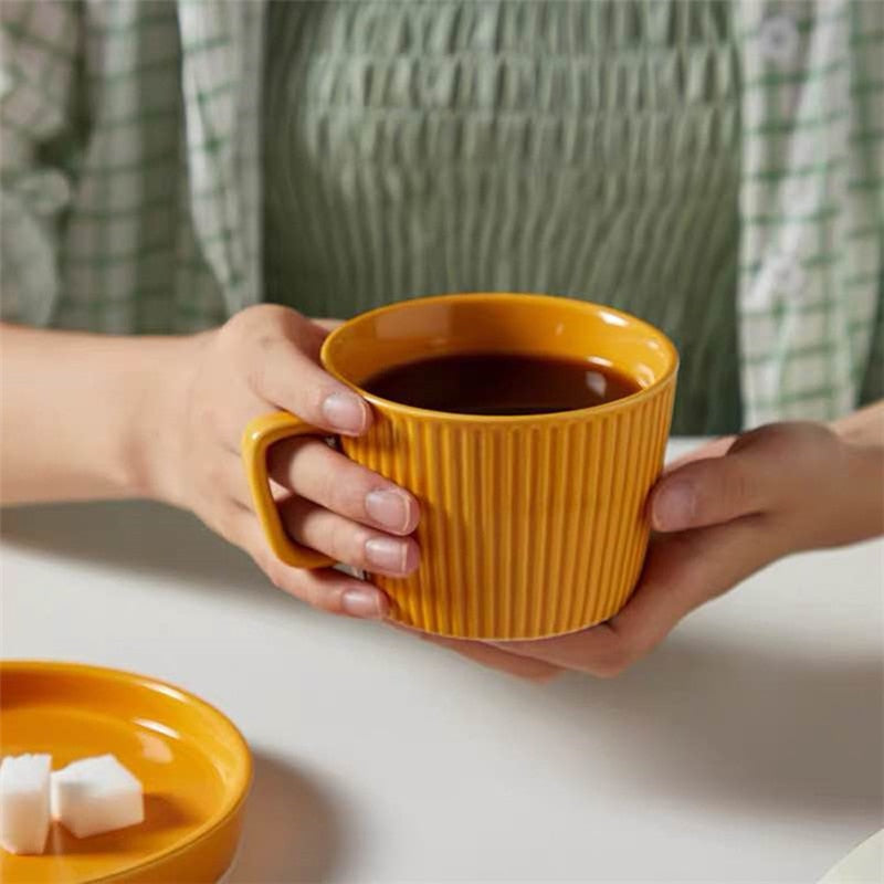 round textured stripe orange ceramic cup with matching saucer